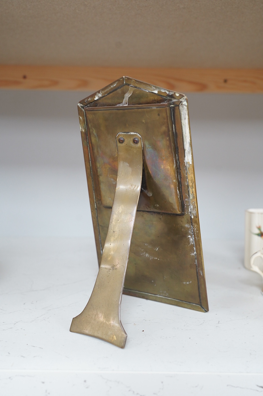 An Art Nouveau embossed brass easel photograph frame, 26cm tall. Condition - fair to good